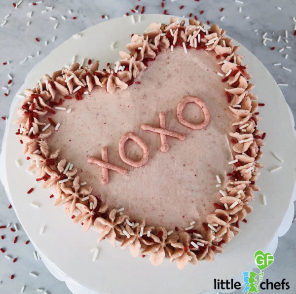 heart shaped pink cake with red and white gluten free sprinkles